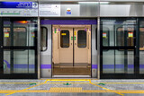 Fototapeta  - View of a metro train with open doors standing at the platform for passengers during the rush hour at a metro station in East West Metro system Kolkata, West Bengal, India