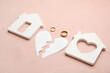 © Pixel-Shot - Figures of house with broken heart and rings on color background