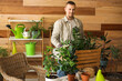 © Pixel-Shot - Young man taking care of plants at home