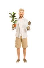 Wall Mural - Young male gardener on white background