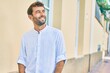 © Krakenimages.com - Handsome man with beard wearing casual white shirt on a sunny day smiling happy outdoors