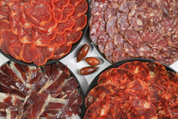 Wall Mural - Several servings of Iberian sausages: Iberian ham, loin, chorizo and 100% acorn-fed salchichón