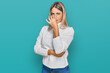 © Krakenimages.com - Beautiful blonde woman wearing casual turtleneck sweater smelling something stinky and disgusting, intolerable smell, holding breath with fingers on nose. bad smell