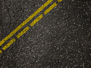 Asphalt road with dividing yellow lines.