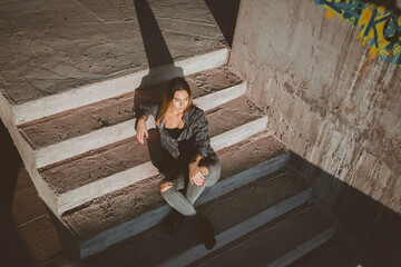 Poster - Young Caucasian woman posing on the stairs