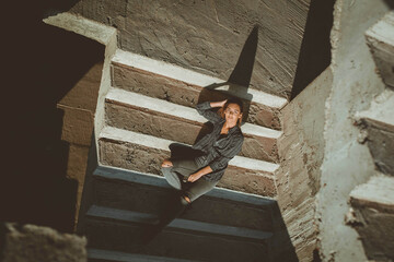 Poster - Young Caucasian woman posing on the stairs