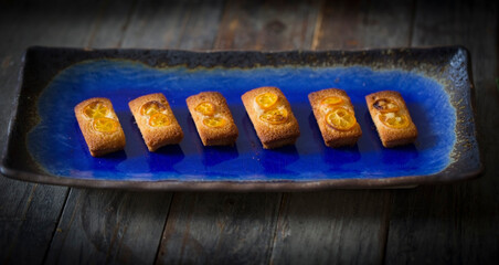 Wall Mural - baked shortbreads with kumquats served on a plate