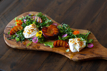 Wall Mural - fresh colorful healthy salad served on a wooden board