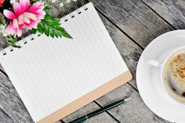 Wall Mural - Empty notebook with pen, coffee cup and flowers on table