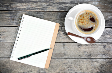 Wall Mural - Empty notepad with pen and coffee cup on table