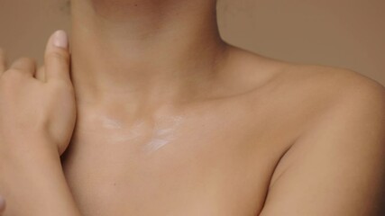 african american woman applying skincare cream on body. close up macro portrait of hands of mixed ra
