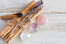 A Close Up Image Of Holy Wood Incense Sticks With Healing Rose Quartz And Amethyst Crystals. 