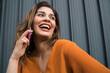 © Mego-studio - Young woman talking on the phone outdoors.