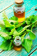 Wall Mural - Glass bottle of nettle tincture,healing herbs