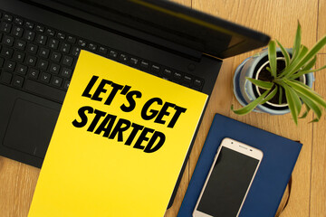 Wall Mural - notepad on workplace table and written let's get started concept