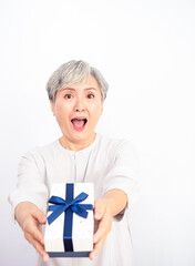 Wall Mural - Senior Asian woman receives gift boxes in white background.