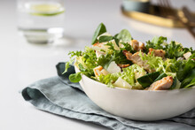 Cesar Salad Plate Served On Restaurant Table.  Healthy Salad With Different  Lettuce, Chicken, Parmesan Cheese And Croutons.