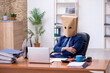 © Elnur - Young male employee with box instead of his head