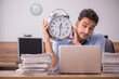 © Elnur - Young male employee unhappy with excessive work in the office