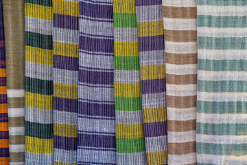 Wall Mural - Handmade colorful Burmese fabric for sell in a tourist stall on the street market near Inle Lake in Burma, Myanmar