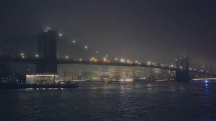Fototapete - Brooklyn bridge and Manhattan at foggy night, New York City.