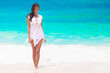 © yellowj - Happy woman walking on beach
