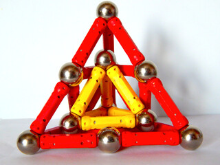 Red and yellow pyramids made of magnetic construction kit