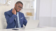 © stockbakers - Tired African Businessman with Laptop having Neck Pain in Office