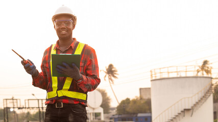 African man engineer use radio communication working at oil industrial