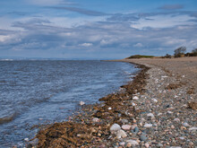 A Deserted Shingle Beach Between Silloth And Grune Point On The Solway Coast In Northwest Cumbria, England, UK. Taken On A Partly Cloudy Day In Spring.