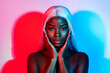 Photo of young beautiful stunning african woman touching cheeks wear artificial wig isolated on vivid colorful background