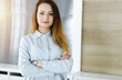 © Iryna - Business woman headshot in sunny office. Unknown businesswoman standing straight with tablet computer. Young accountant or secretary looks good