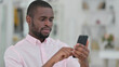 © stockbakers - Portrait of Serious African Man using Smartphone