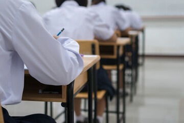 Wall Mural - writing test in exam with behind girl asian students group concentrate in high school, serious takin