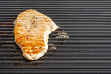 Canvas Print - Chicken steak on a grill. Free space for text.