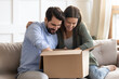 © fizkes - Excited millennial Caucasian couple unpack unbox package shopping online on internet from home together. Happy young man and woman open parcel with web order. Good delivery service concept.