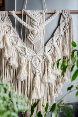 Wall Mural - Macrame. Handmade macrame weaving and cotton threads on a rustic wooden stick. Scandinavian style in the interior, boho style. Cozy home