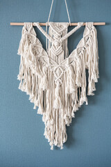 Wall Mural - Macrame. Handmade macrame weaving and cotton threads on a rustic wooden stick. Scandinavian style in the interior, boho style. Cozy home