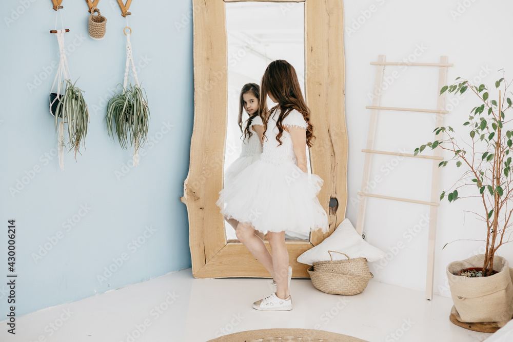 preteen flower girl in white dress with a bouquet of white gypsophila ...