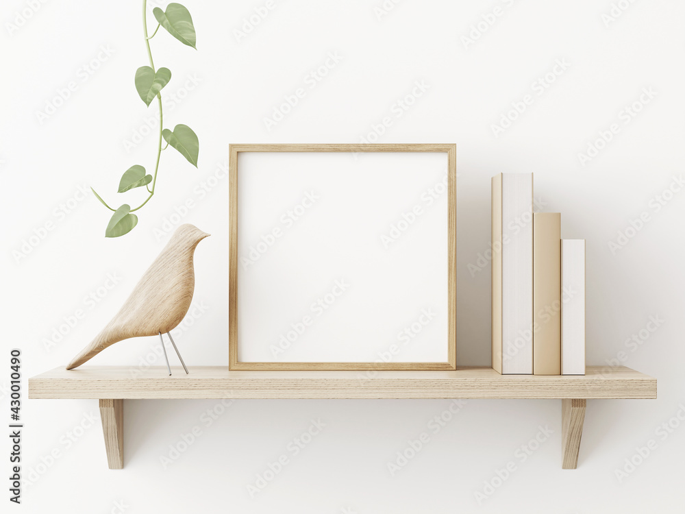 Small square wooden frame mockup in scandi style interior with trailing green plant, bird, pile of books and shelf on empty neutral white wall background. 3d rendering, illustration - obrazy, fototapety, plakaty 