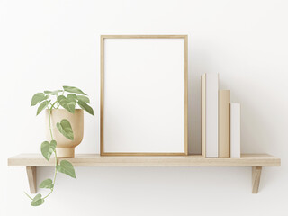 small vertical wooden frame mockup in scandi style interior with trailing green plant in pot, pile o