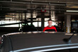© brillianata - A young man in a tracksuit stands next to a car in an underground parking lot