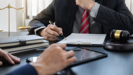 Professional lawyer advising a client on commercial contract legal in service office. Justice, Law, Attorney and Court judge concept.