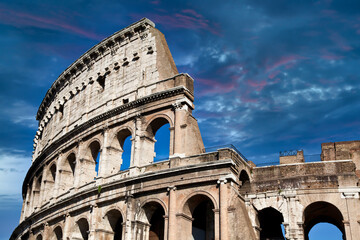 Wall Mural - Rome, Italy. Arches archictecture of Colosseum exterior with blue sky background and clouds.