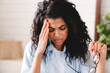 © InsideCreativeHouse - Close up shot of a tired sick young african woman working in the office. Bored young african american girl tired of learning sit at home looking at laptop