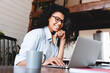 © InsideCreativeHouse - Young african woman buying online on laptop at home. African American womanshopping online with credit card for payment. Happy young girl buy purchase on internet use secure service paying system