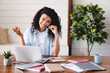 © InsideCreativeHouse - Positive young afro woman hotline worker IT support at her working place. Smiling customer service representative afro at the computer using headset
