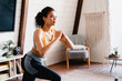 © InsideCreativeHouse - Young fit afro woman in sporty clothes doing fitness exercises at home. Slim young African American girl takes care about her health, does sports at home on fitness mat, does sit-ups
