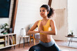 © InsideCreativeHouse - Young fit african woman keeping balance doing execises at home. Beautiful sporty black woman doing warming up stretching exercses on yoga mat in her home gym