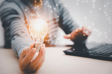 thinking and creative concept, Close up light bulb and working on the desk, Creativity and innovation are keys to success.Concept of new idea and innovation with Brain and light bulbs, working at home